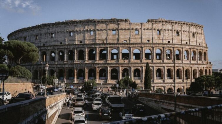 The Colosseum stands majestically amidst bustling Rome, an iconic remnant of ancient architecture.
